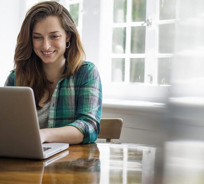 Parent attends virtual information session on computer - Connections Academy